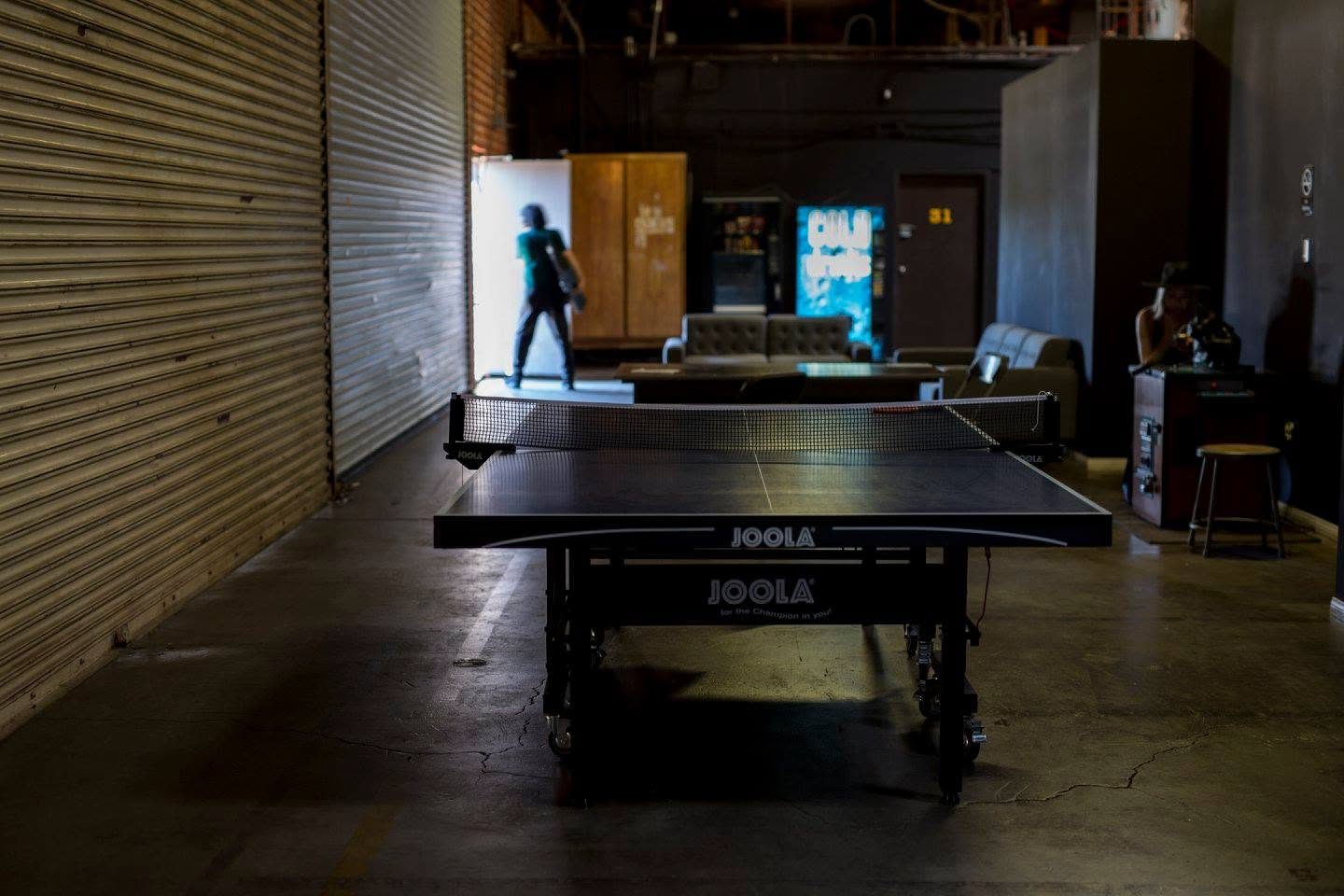 Ping pong table in the common area with the lounge and vending machines behind