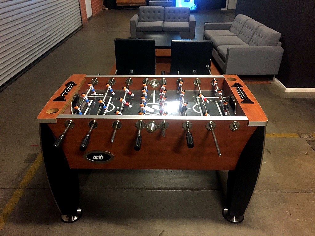 Foosball table in front of the lounge couches